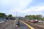 A westbound MBTA on the NEC while an outbound heading to the Franklin Line approaches the Readville Sta